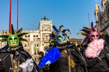 Italy, Venice, 2019, carnival, people with beautiful masks walk around Piazza San Marco, in the streets and canals of the city, posing for photographers and tourists, with colorful clothes.