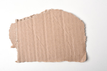 Piece of corrugated cardboard torn, isolated on white background. Cardboard texture ragged edge.