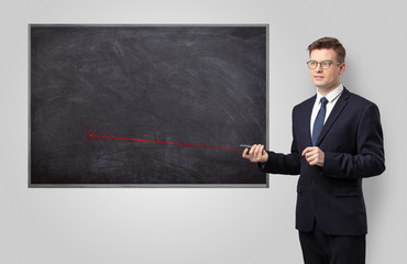 Handsome young teacher with laser pointer teaching 
