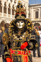 Fototapeta na wymiar Italy, Venice, carnival 2019, typical masks, beautiful clothes, posing for photographers and tourists in Piazza San Marco.
