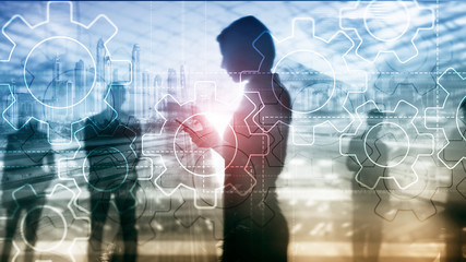 Double exposure gears mechanism on blurred background. Business and industrial process automation concept.