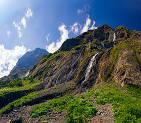 Brooks flow down from the mountains around Dombay on a summer day.