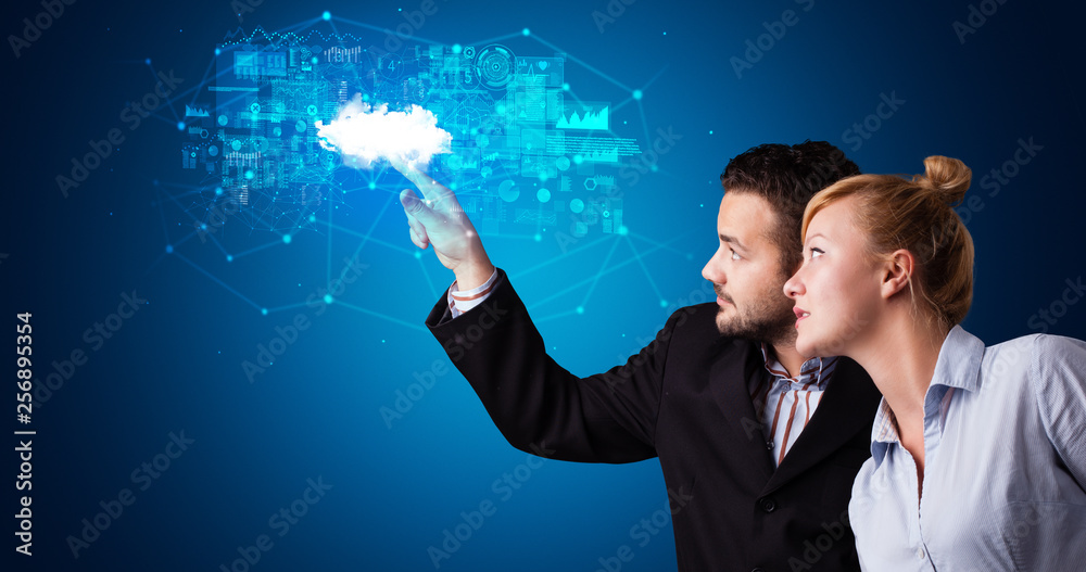 Aufkleber Man and woman touching hologram projection displaying information from cloud based system
