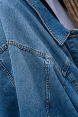 Close-up. Girl with dreadlocks in casual jeanswear walk the street