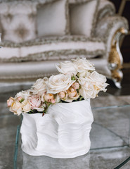 Beautiful rose in vase on table in room