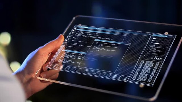 technology, virtual effects and programming concept - hand holding transparent tablet pc computer with coding on screen