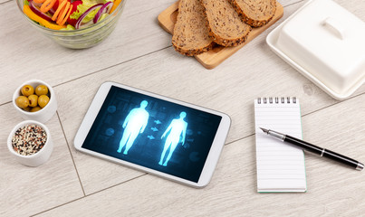 Arrangement of healthy Ingredients with a tablet. Dieting concept