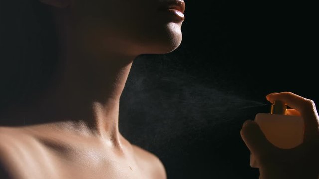 Close up of woman with bottle of perfume