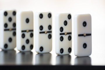 domino tiles in a row on a black background