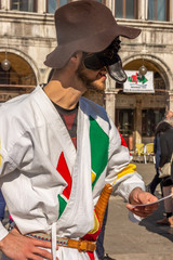 Italy, Venice, 2019, carnival, people with beautiful masks walk around Piazza San Marco, in the streets and canals of the city, posing for photographers and tourists, with colorful clothes.