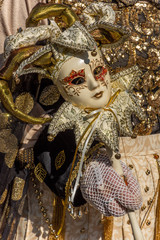Fototapeta na wymiar Italy, Venice, 2919 carnival, typical masks, beautiful clothes, posing for photographers and tourists. Details of the dress and objects.