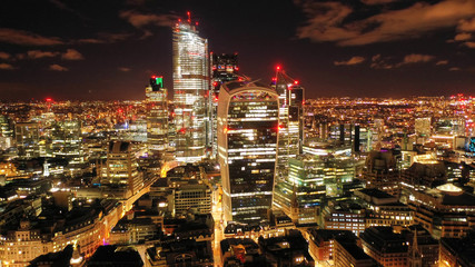 Aerial drone panoramic night shot of iconic financial district and skyscrapers in City of London, United Kingdom