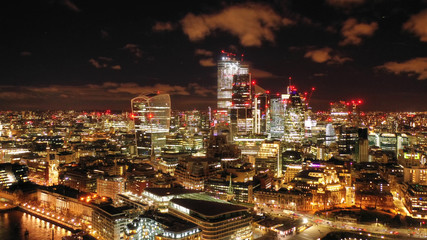 Aerial drone panoramic night shot of iconic financial district over river Thames in City of London, United Kingdom