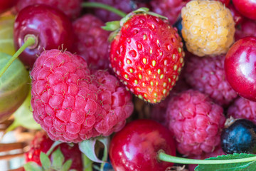 Fresh ripe berries background: raspberries, strawberries, cherry
