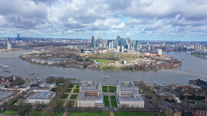 Fototapeta na wymiar Aerial bird's eye view panoramic drone photo of Greenwich park with views to Canary Wharf and University of Greenwich with beautiful cloudy sky, Isle of Dogs, London, United Kingdom
