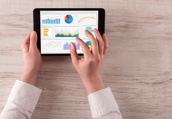 Hand making diagrams and charts on tablet