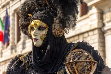 Italy, Venice, carnival, 2019, masked people roam the city, posing for photographers and tourists, with beautiful clothes.