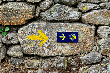 Shell sign and arrow of ancient pilgrim routes The Way of Saint James.