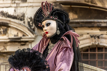 Obraz na płótnie Canvas Italy, Venice, carnival 2019, typical masks, beautiful clothes, posing for photographers and tourists.