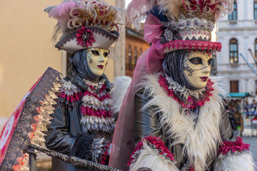 Obraz na płótnie Canvas Italy, Venice, carnival 2019, typical masks, beautiful clothes, posing for photographers and tourists.