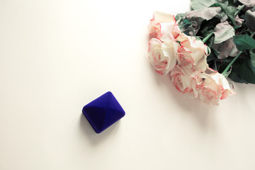 Gift box with decorations and roses on the table