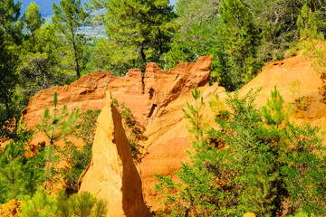 Strange cliff from red earth in ocher quarries of Roussillon in France