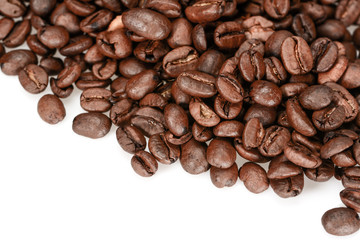 Roasted coffee beans, dark brown close up isolated on a white background