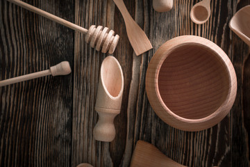 Wooden kitchen utensils isolated on wood background