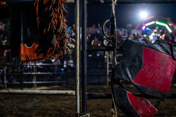 bull riding gear on gate in Guatemalan rodeo