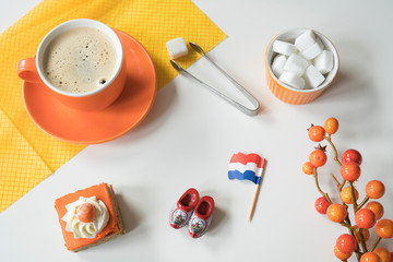 coffee, orange cake, flag and wooden shoe for typical Dutch event Koningsdag, Kings day