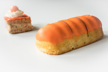orange cake and eclaire, party food for typical Dutch event Koningsdag, Kings day