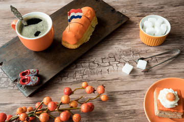 cup of coffee, orange cake and eclaire for typical Dutch event Koningsdag, Kings day
