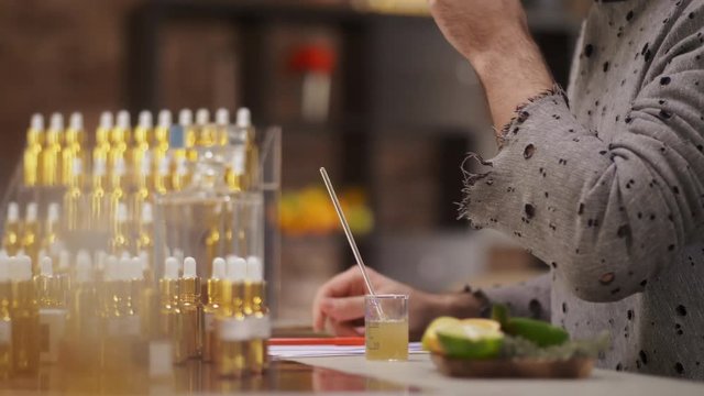 Male perfumer smelling orange selecting scents for his new perfume