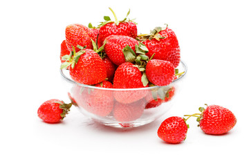 Image of green strawberry in glass cup on empty white background.