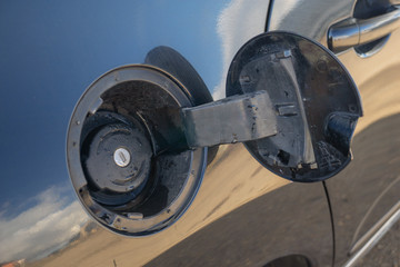 Exterior of car with fuel filler door open.