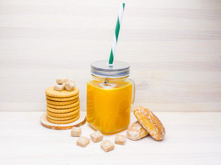 Tangerine citrus tea from mandarins in a transparent jar with a cocktail straw