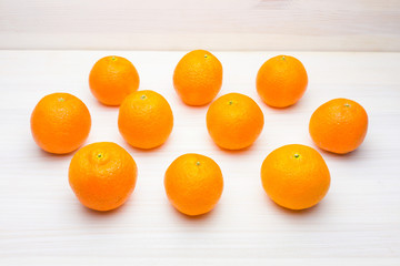 Ripe tangerines (mandarins) on a white wooden background