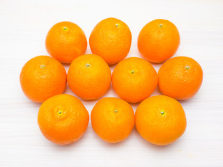 Ripe tangerines (mandarins) on a white wooden background