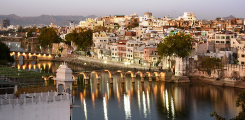 city view with lake pichola and Chand Pole Puliya bridge by night, Udaipur, Rajasthan, india