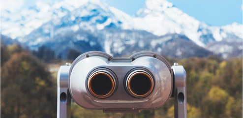 touristic telescope look at the city with view snow mountains, closeup binocular on background viewpoint observe vision, metal coin operated in panorama observation, travel nature concept