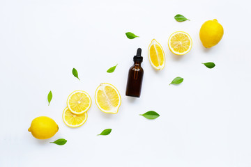 Fresh lemon with lemon essential oil on a white background.