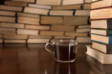 cup of coffee on the background of books