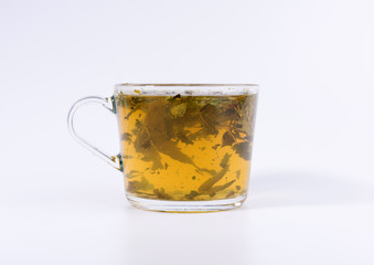 green herbal tea in a transparent cup isolated on white background