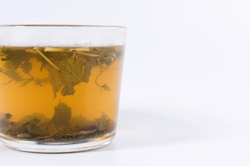 green herbal tea in a transparent cup isolated on white background