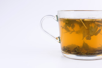 green herbal tea in a transparent cup isolated on white background