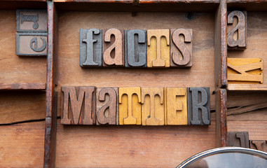 Fact Matter in wooden typeset letters. 