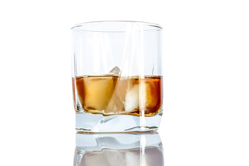 Whiskey with ice close-up in a glass isolated on a white background