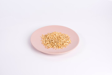 pile of oatmeal on a plate isolated on white background
