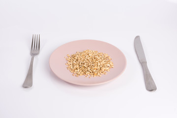pile of oatmeal on a plate isolated on white background
