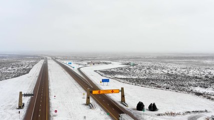 Aerial pull out shot welcome to New Mexico winter snow storm
